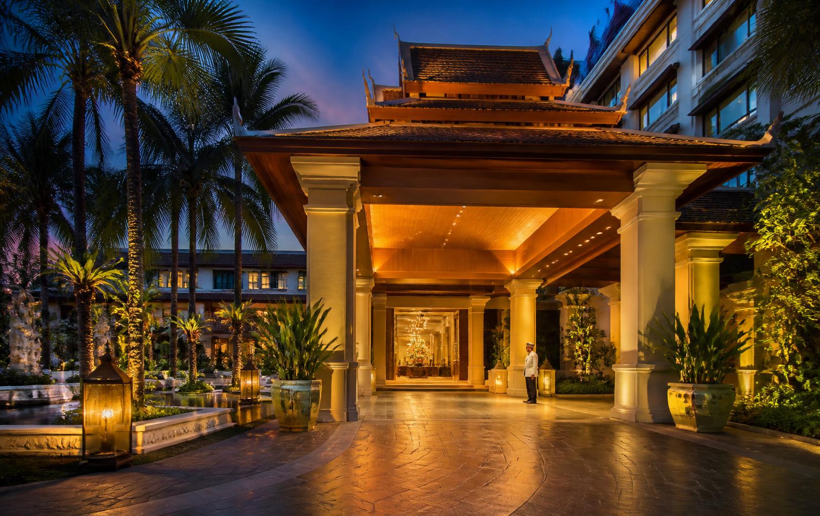 Illuminated entrance of a five-star Bangkok hotel at dusk
